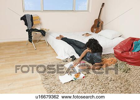 High angle view of a man eating pizza in the bedroom View Large Photo Image Stock Image - High angle view of a man eating pizza in the bedroom. Fotosearch