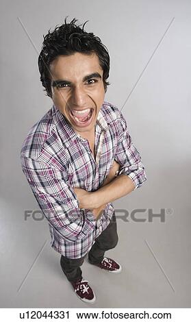 High angle view of a man standing with mouth open View Large Photo Image Stock Image - High angle view of a man standing with mouth open. Fotosearch