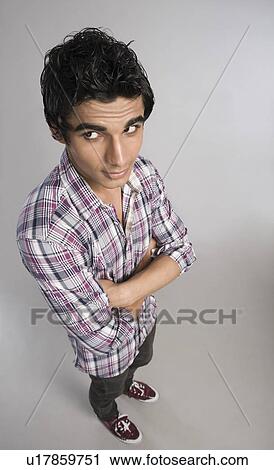 High angle view of a man standing with arms crossed View Large Photo Image Stock Image - High angle view of a man standing with arms crossed. Fotosearch