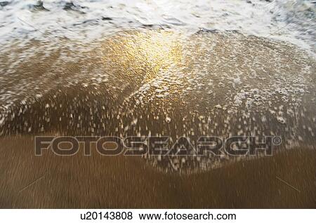 Stock Photo - High angle view of surf on the beach, Goa, India. Fotosearch