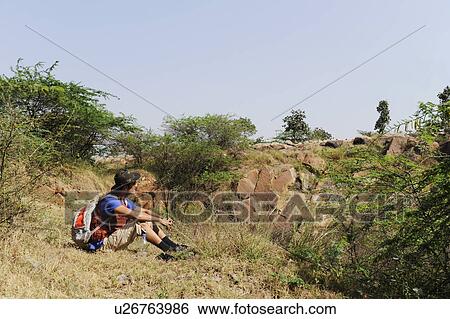 Hiker sitting in a forest View Large Photo Image Stock Photograph - Hiker sitting in a forest. Fotosearch