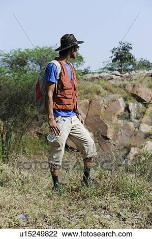 Hiker standing in a forest View Large Photo Image Stock Image - Hiker standing in a forest. Fotosearch