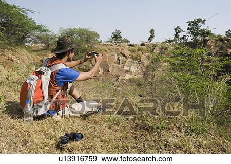 Hiker taking a picture with a mobile phone View Large Photo Image Stock Photo - Hiker taking a picture with a mobile phone. Fotosearch