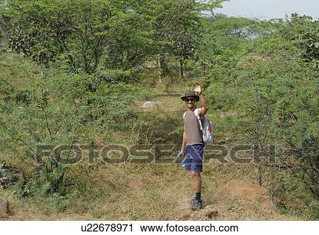 Hiker waving hand in a forest View Large Photo Image Stock Image - Hiker waving hand in a forest. Fotosearch