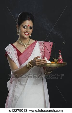 Indian woman in traditional clothing holding religious offering View Large Photo Image Stock Image - Indian woman in traditional clothing holding religious offering. Fotosearch
