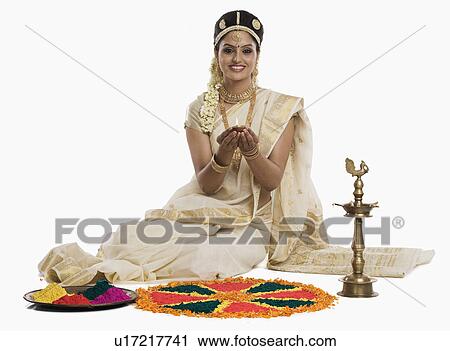 Indian woman in traditional clothing praying with an oil lamp at Durga puja festival View Large Photo Image Stock Image - Indian woman in traditional clothing praying with an oil lamp at Durga puja festival. Fotosearch