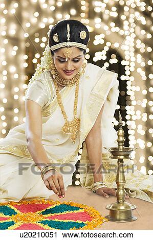 Indian woman in traditional clothing making rangoli at Durga festival View Large Photo Image Stock Image - Indian woman in traditional clothing making rangoli at Durga festival. Fotosearch