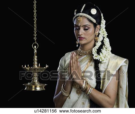 Indian woman in traditional clothing praying at Durga puja festival View Large Photo Image Stock Photograph - Indian woman in traditional clothing praying at Durga puja festival. Fotosearch