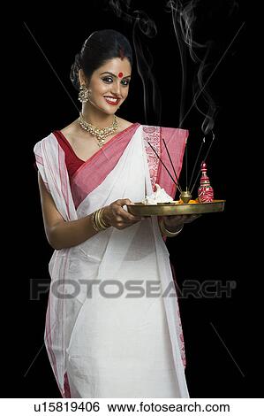 Indian woman in traditional clothing holding religious offering View Large Photo Image Stock Photograph - Indian woman in traditional clothing holding religious offering. Fotosearch
