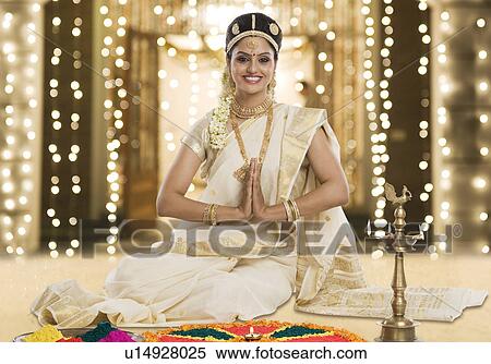 Indian woman in traditional clothing praying at Durga puja festival View Large Photo Image Stock Photography - Indian woman in traditional clothing praying at Durga puja festival. Fotosearch