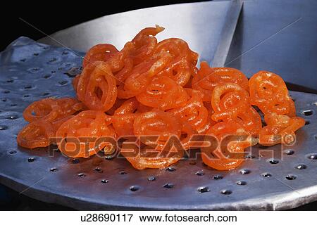 Stock Photo - Jalebis (An Indian traditional sweet food) at a market stall, Delhi, India. Fotosearch