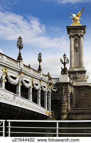 Stock Image - Lampposts on a bridge, Pont Alexandre III, Seine River, Paris, France. Fotosearch