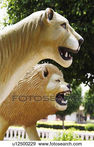 Stock Photo - Lion statues at a park, Chhatarpur Temple, New Delhi, India. Fotosearch
