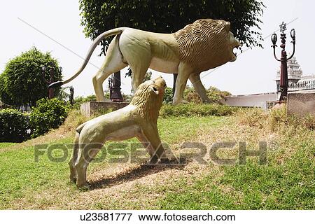 Stock Photo - Lion statues at a park, Chhatarpur Temple, New Delhi, India. Fotosearch