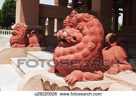 Stock Photograph - Lion statues at the entrance of a temple, Chhatarpur Temple, New Delhi, India. Fotosearch