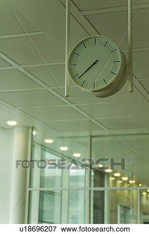 Stock Photo - Low angle view of a clock at an airport lounge, Paris, France. Fotosearch