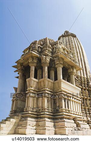 Stock Image - Low angle view of a temple, Kandariya Mahadeva Temple, Khajuraho, Chhatarpur District, Madhya Pradesh, India. Fotosearch