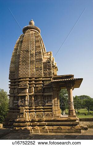 Stock Image - Low angle view of a temple, Kandariya Mahadeva Temple, Khajuraho, Chhatarpur District, Madhya Pradesh, India. Fotosearch