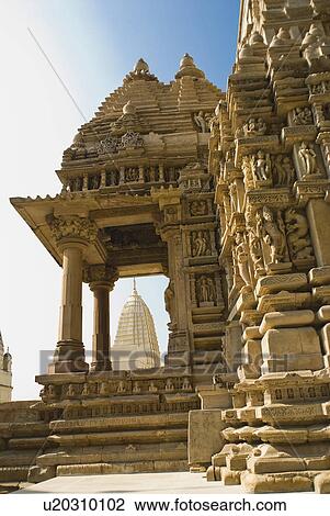 Stock Image - Low angle view of a temple, Kandariya Mahadeva Temple, Khajuraho, Chhatarpur District, Madhya Pradesh, India. Fotosearch