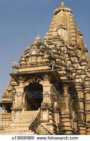 Low angle view of a temple, Kandariya Mahadeva Temple, Khajuraho, Chhatarpur District, Madhya Pradesh, India View Large Photo Image Stock Photo - Low angle view of a temple, Kandariya Mahadeva Temple, Khajuraho, Chhatarpur District, Madhya Pradesh, India. Fotosearch