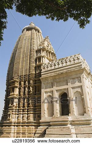Low angle view of a temple, Kandariya Mahadeva Temple, Khajuraho, Chhatarpur District, Madhya Pradesh, India View Large Photo Image Stock Photograph - Low angle view of a temple, Kandariya Mahadeva Temple, Khajuraho, Chhatarpur District, Madhya Pradesh, India. Fotosearch