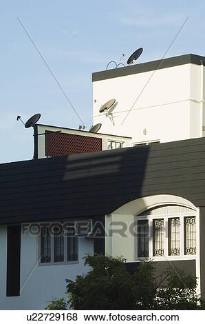 Stock Photo - Low angle view of satellite dishes on a house, Tirupati, Andhra Pradesh, India. Fotosearch