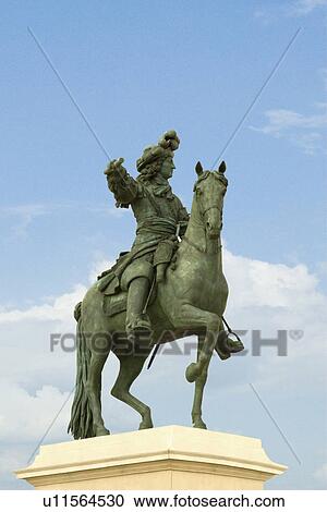 Stock Image - Low angle view of statue of Louis XIV, Chateau de Versailles, Versailles, Paris, France. Fotosearch