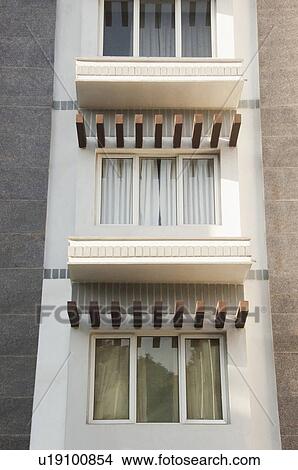 Picture - Low angle view of windows of a building, Tirupati, Andhra Pradesh, India. Fotosearch