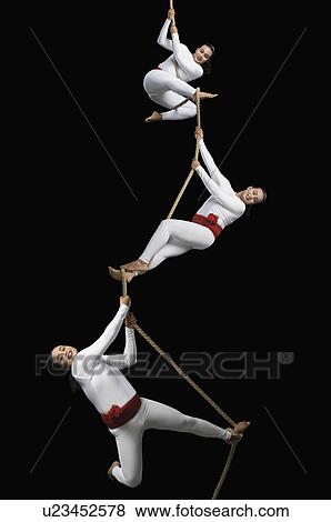 Male acrobats performing on a rope View Large Photo Image Stock Photo - Male acrobats performing on a rope. Fotosearch