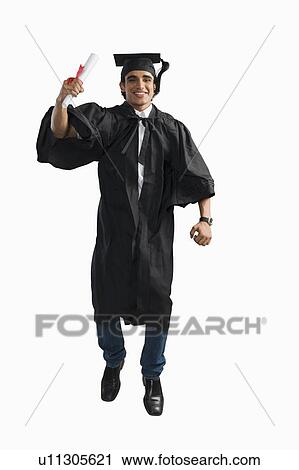 Stock Image - Male graduate cheering with his diploma. Fotosearch