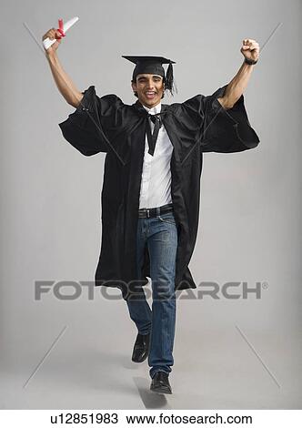 Stock Image - Male graduate cheering with his diploma. Fotosearch