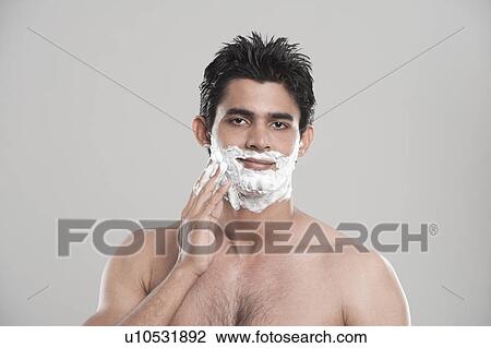 Man applying shaving cream on face View Large Photo Image Stock Image - Man applying shaving cream on face. Fotosearch