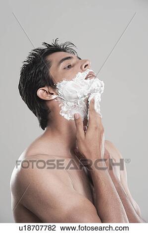 Man applying shaving cream on face View Large Photo Image Stock Image - Man applying shaving cream on face. Fotosearch