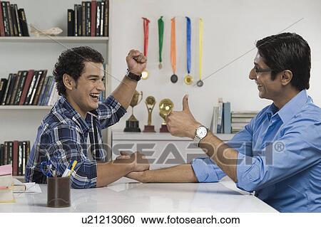 Man celebrating after defeat his father in arm wrestling View Large Photo Image Stock Image - Man celebrating after defeat his father in arm wrestling. Fotosearch
