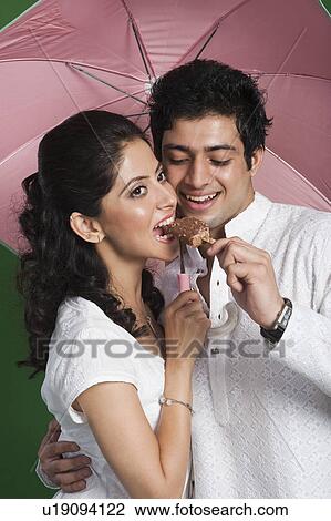 Man feeding an ice cream to a woman View Large Photo Image Stock Image - Man feeding an ice cream to a woman. Fotosearch