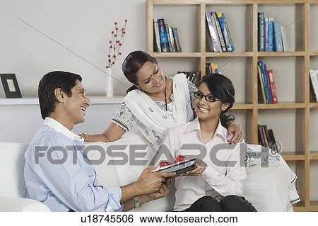 Man gifting a laptop to his daughter View Large Photo Image Stock Photograph - Man gifting a laptop to his daughter. Fotosearch