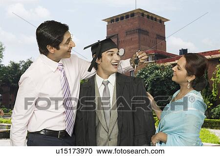 Man giving a car key to his son after his success View Large Photo Image Stock Image - Man giving a car key to his son after his success. Fotosearch