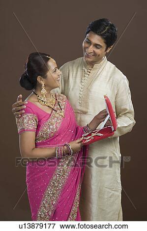 Man giving a jewelry box to his wife in present View Large Photo Image Stock Photo - Man giving a jewelry box to his wife in present. Fotosearch