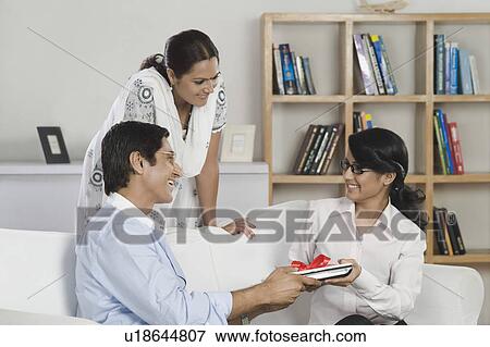 Man giving a laptop to his daughter in gift View Large Photo Image Stock Photo - Man giving a laptop to his daughter in gift. Fotosearch