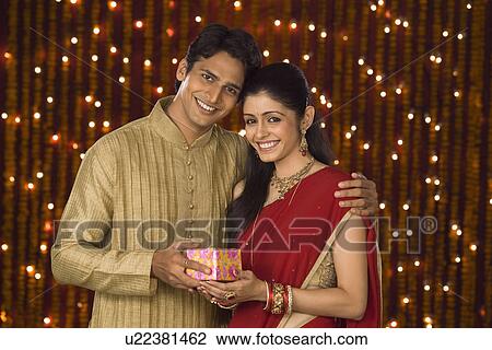 Man giving Diwali gift to his wife View Large Photo Image Stock Image - Man giving Diwali gift to his wife. Fotosearch