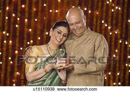 Man giving Diwali gift to his wife View Large Photo Image Stock Photo - Man giving Diwali gift to his wife. Fotosearch