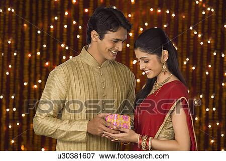 Man giving Diwali gift to his wife View Large Photo Image Stock Photo - Man giving Diwali gift to his wife. Fotosearch