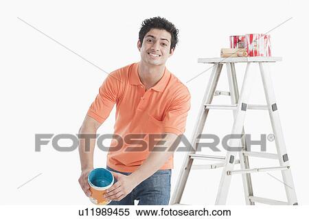 Man holding a paint can View Large Photo Image Stock Photography - Man holding a paint can. Fotosearch