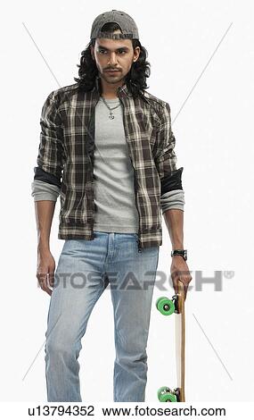 Man holding a skateboard View Large Photo Image Stock Image - Man holding a skateboard. Fotosearch