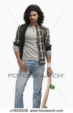 Man holding a skateboard View Large Photo Image Stock Photo - Man holding a skateboard. Fotosearch