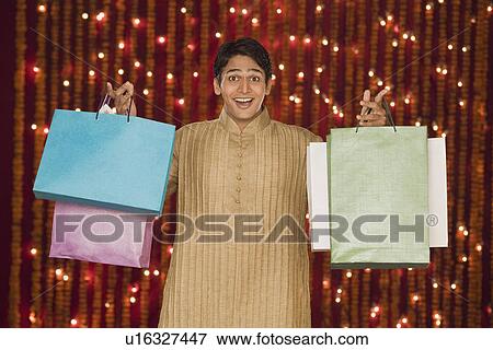 Man holding shopping bags View Large Photo Image Stock Photo - Man holding shopping bags. Fotosearch