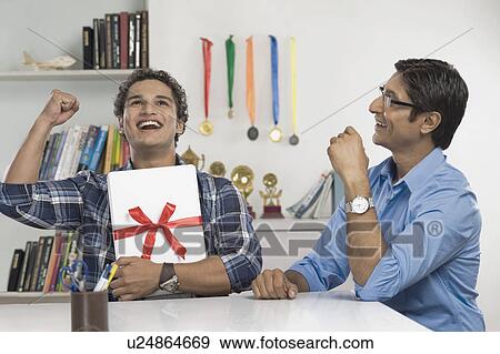 Man hugging a laptop and celebrating View Large Photo Image Stock Photo - Man hugging a laptop and celebrating. Fotosearch