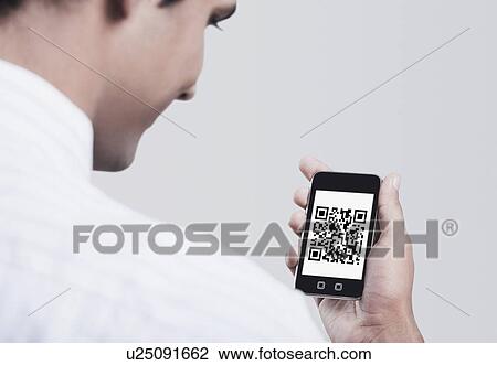 Man looking at the 2D Barcode on a mobile phone View Large Photo Image Stock Image - Man looking at the 2D Barcode on a mobile phone. Fotosearch