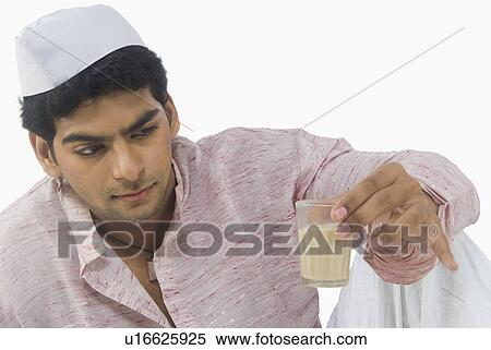 Man looking at the glass of tea View Large Photo Image Stock Photography - Man looking at the glass of tea. Fotosearch