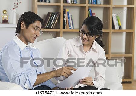 Man looking the report card of his daughter View Large Photo Image Stock Image - Man looking the report card of his daughter. Fotosearch